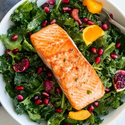 Homemade Kale Salad Recipe With Salmon, Pomegranate, And Orange-Coconut Vinaigrette photo